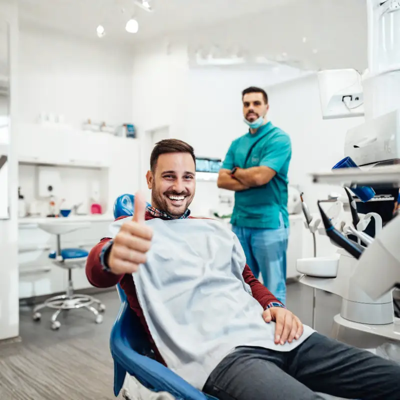Patient smiling during dental checkup at Levin Dental Centre in a modern, comfortable clinic